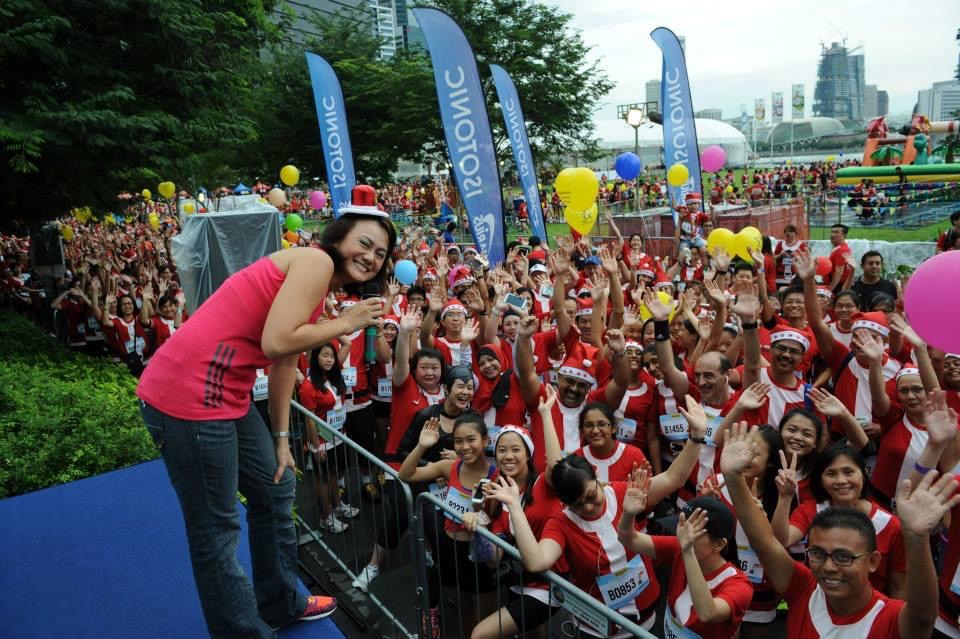 Cynthia emceeing the Make-A-Wish Santa Run — Singapore